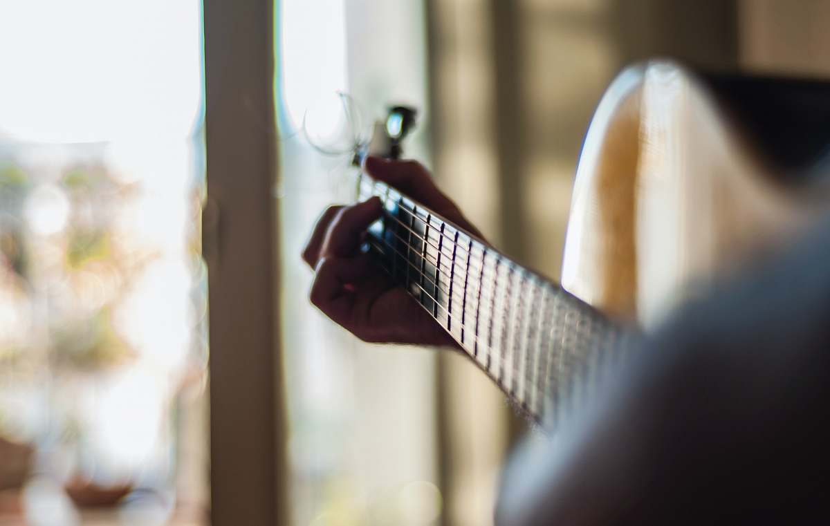 guitar person playing guitar indoors electric guitar
